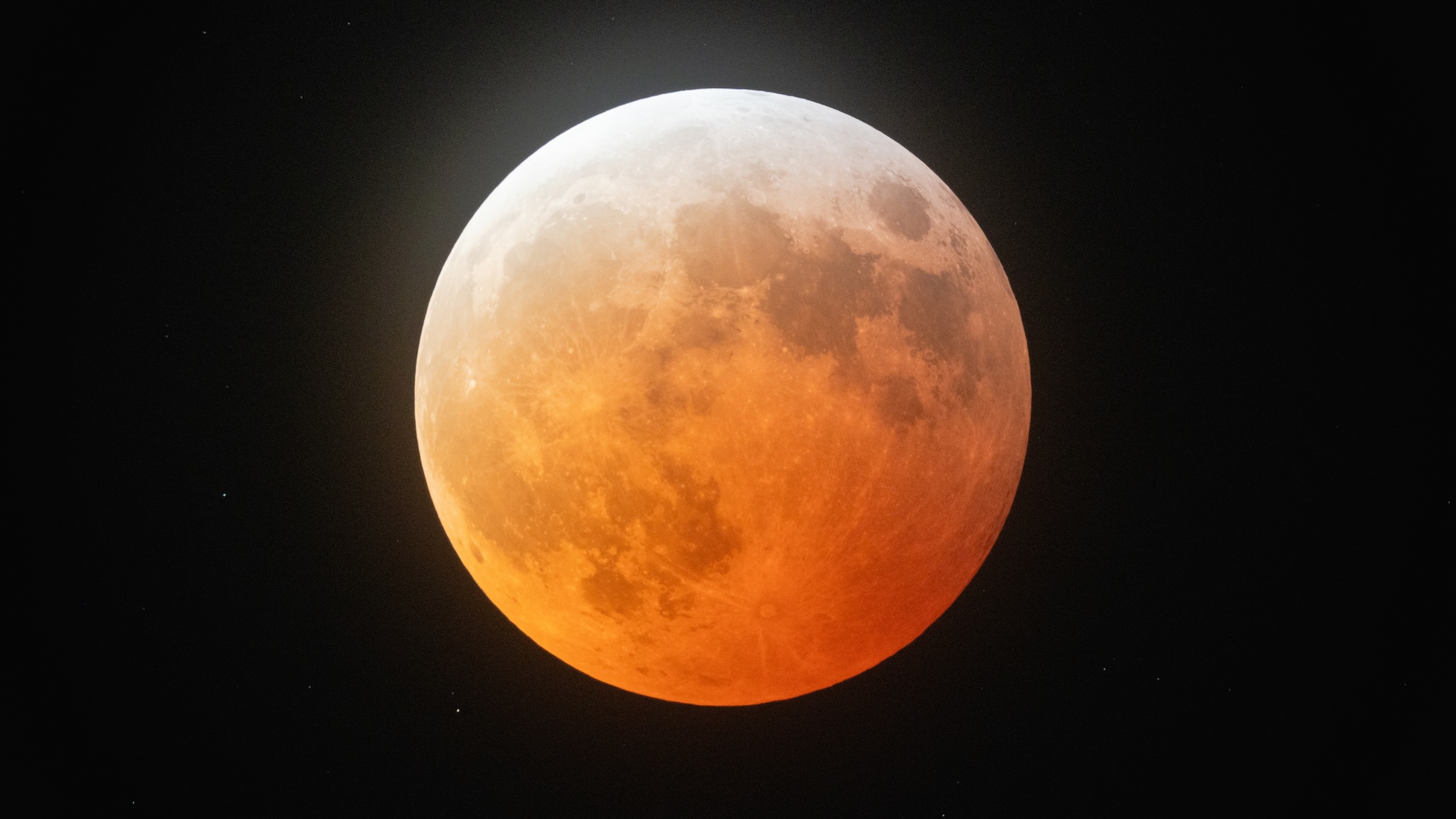 a full moon with an orange hue