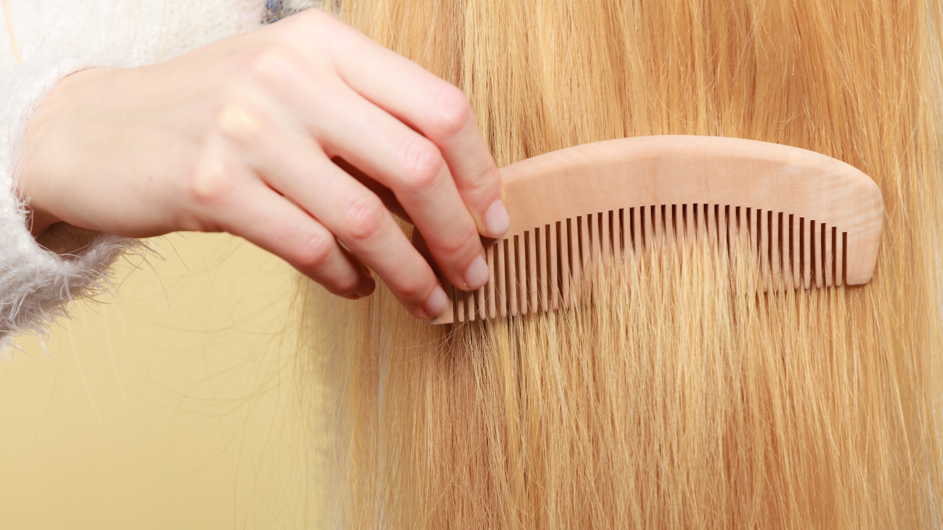 a close-up of a comb going through straight hair