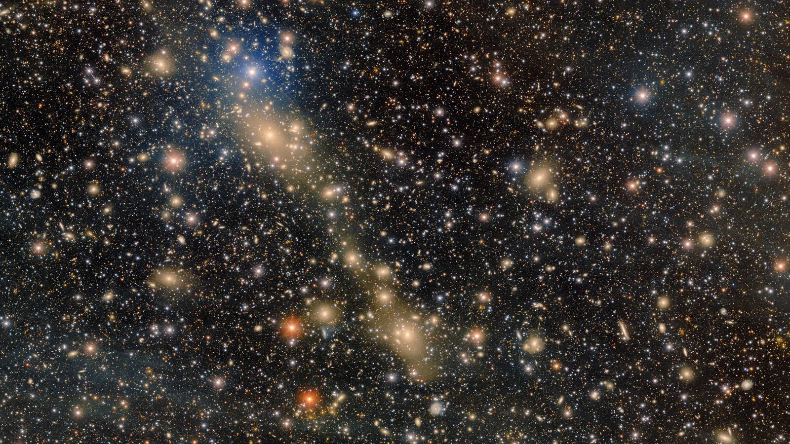 Des milliers d'étoiles de différentes nuances d'or et de blanc scintiller dans l'obscurité de l'espace, avec une séquence d'or qui les traverse