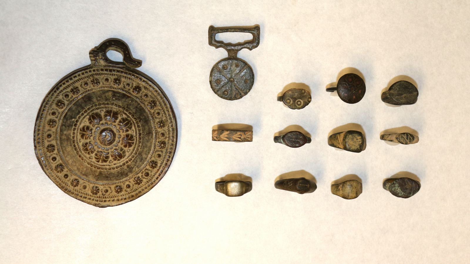 Complete set of artifacts donated to SFU for study laid out on a white table.