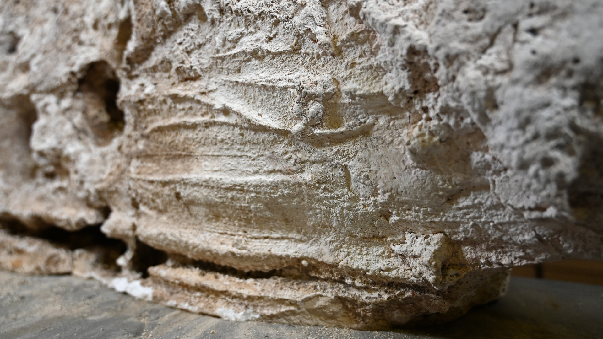 finger marks drag horizontally across plaster