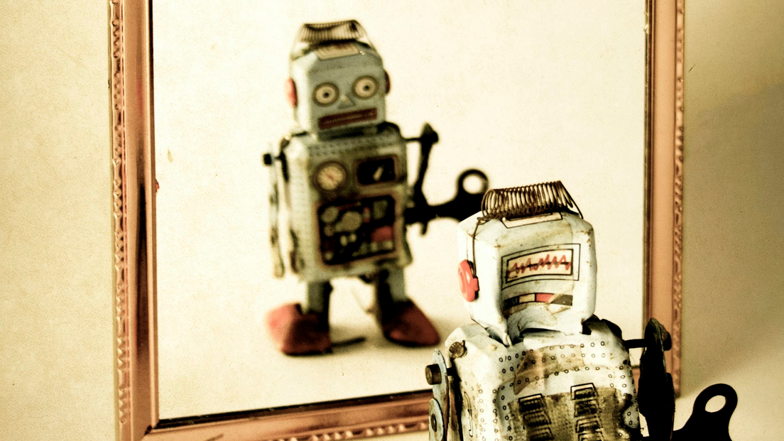 Un robot qui se regarde dans un miroir.