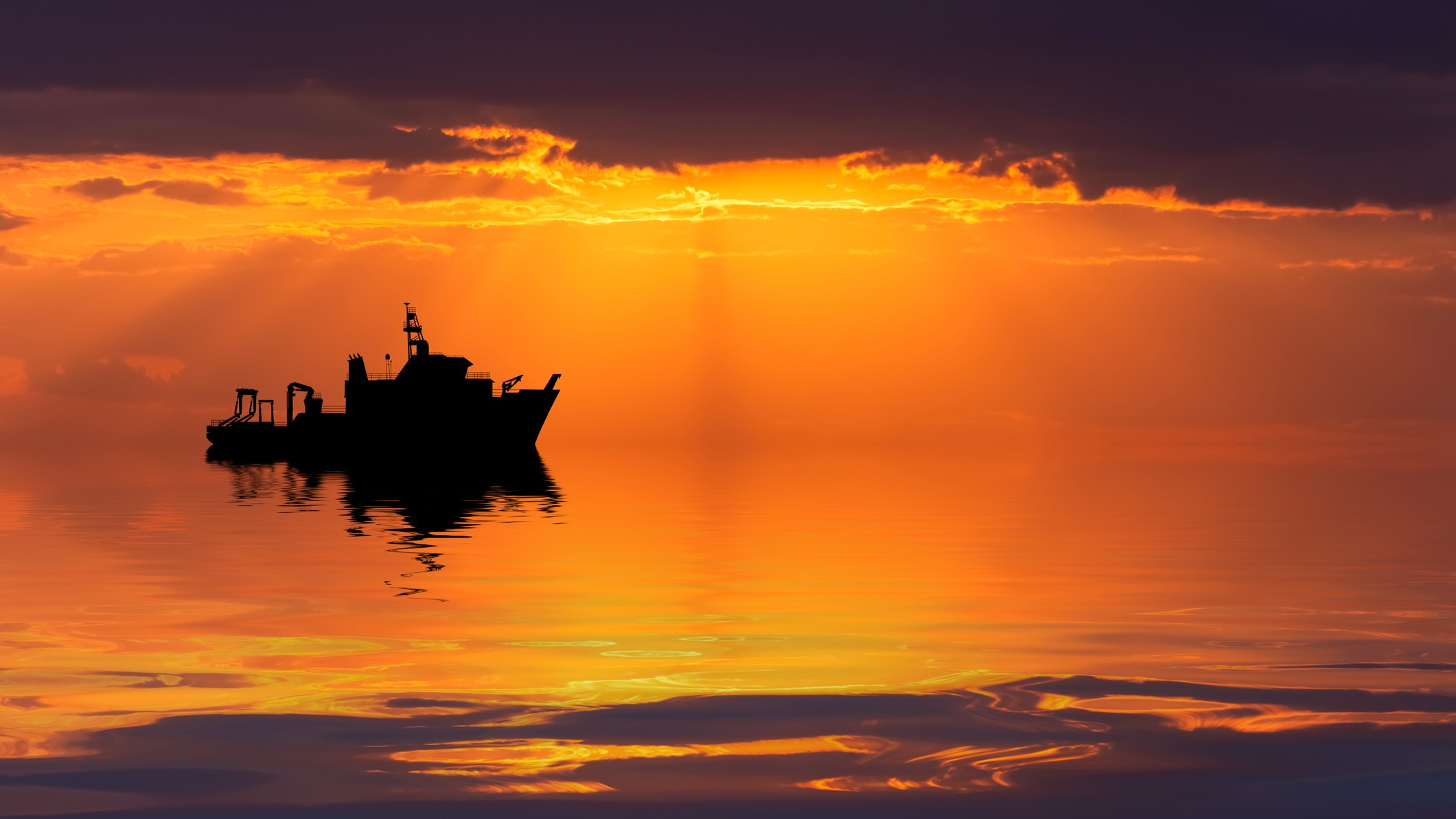 Un navire de recherche en mer au coucher du soleil.