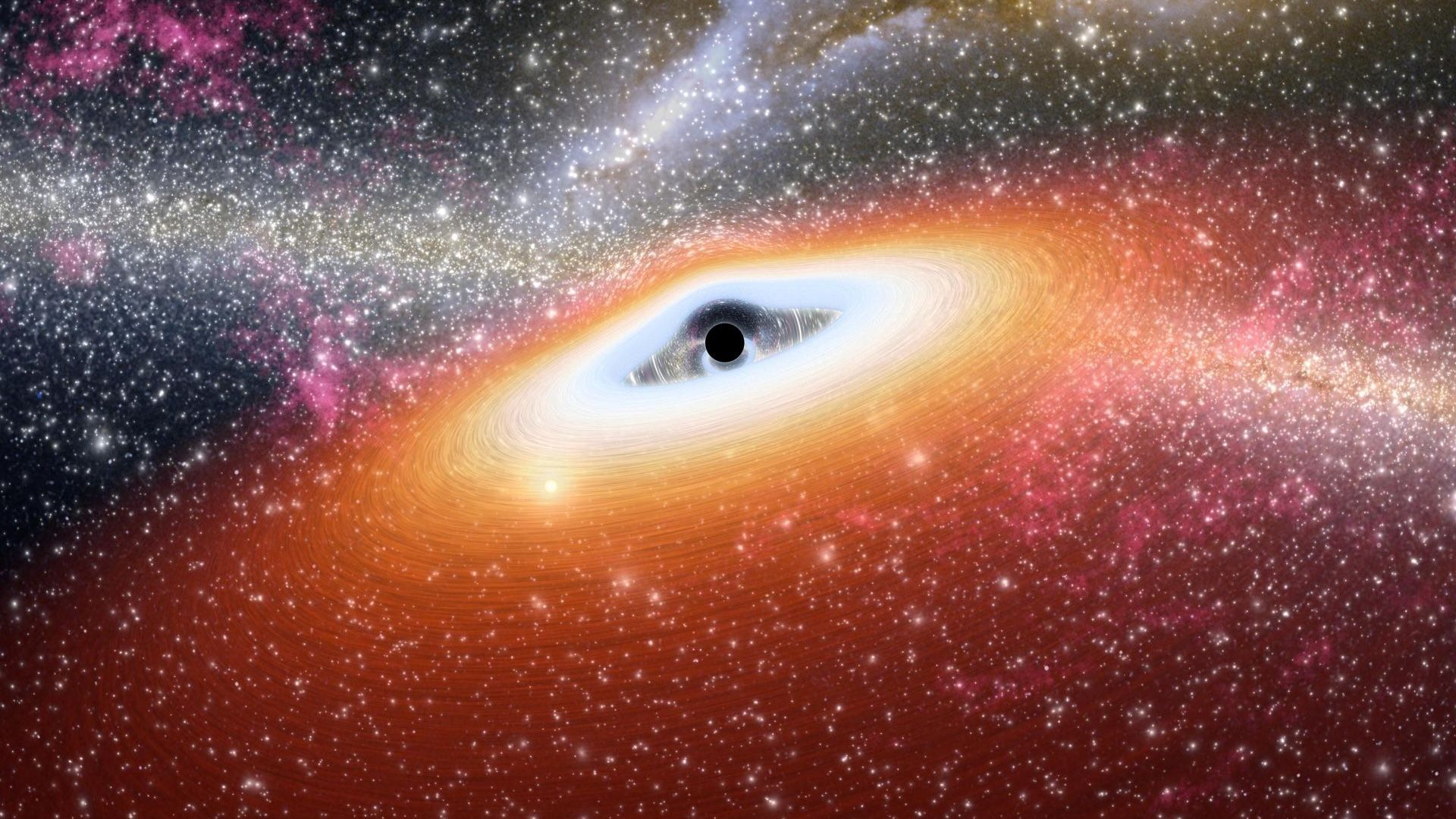 An artist's illustration of a black hole in yellow, blue and pink light