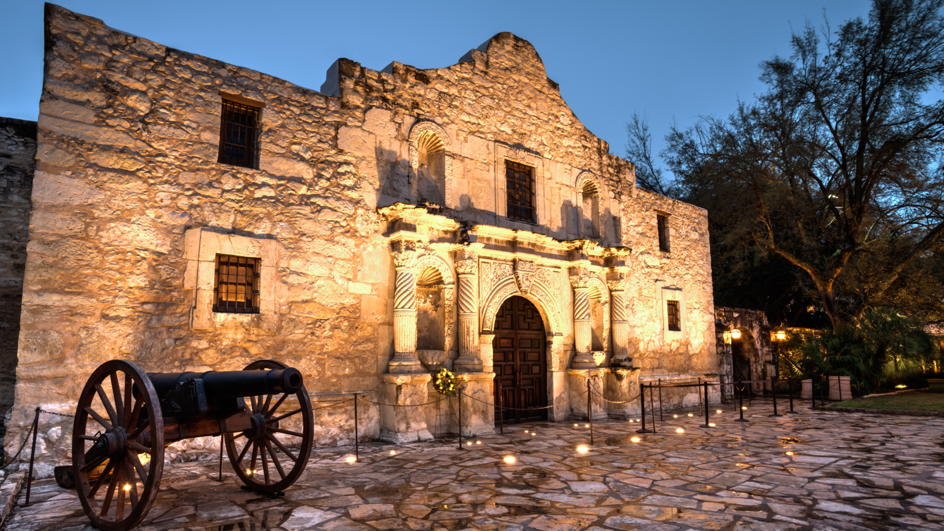 alamo at twilight with a cannon in the foreground