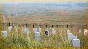 A view of a gravesite with various gray tombstones