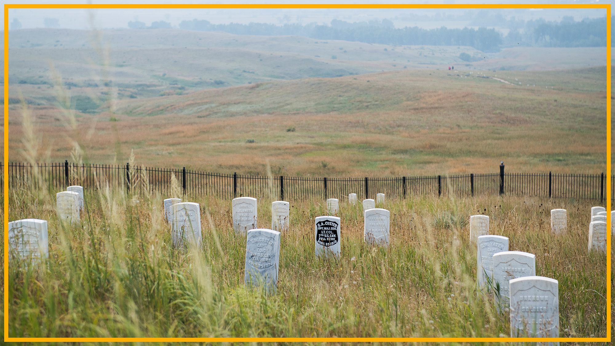 A view of a gravesite with various gray tombstones