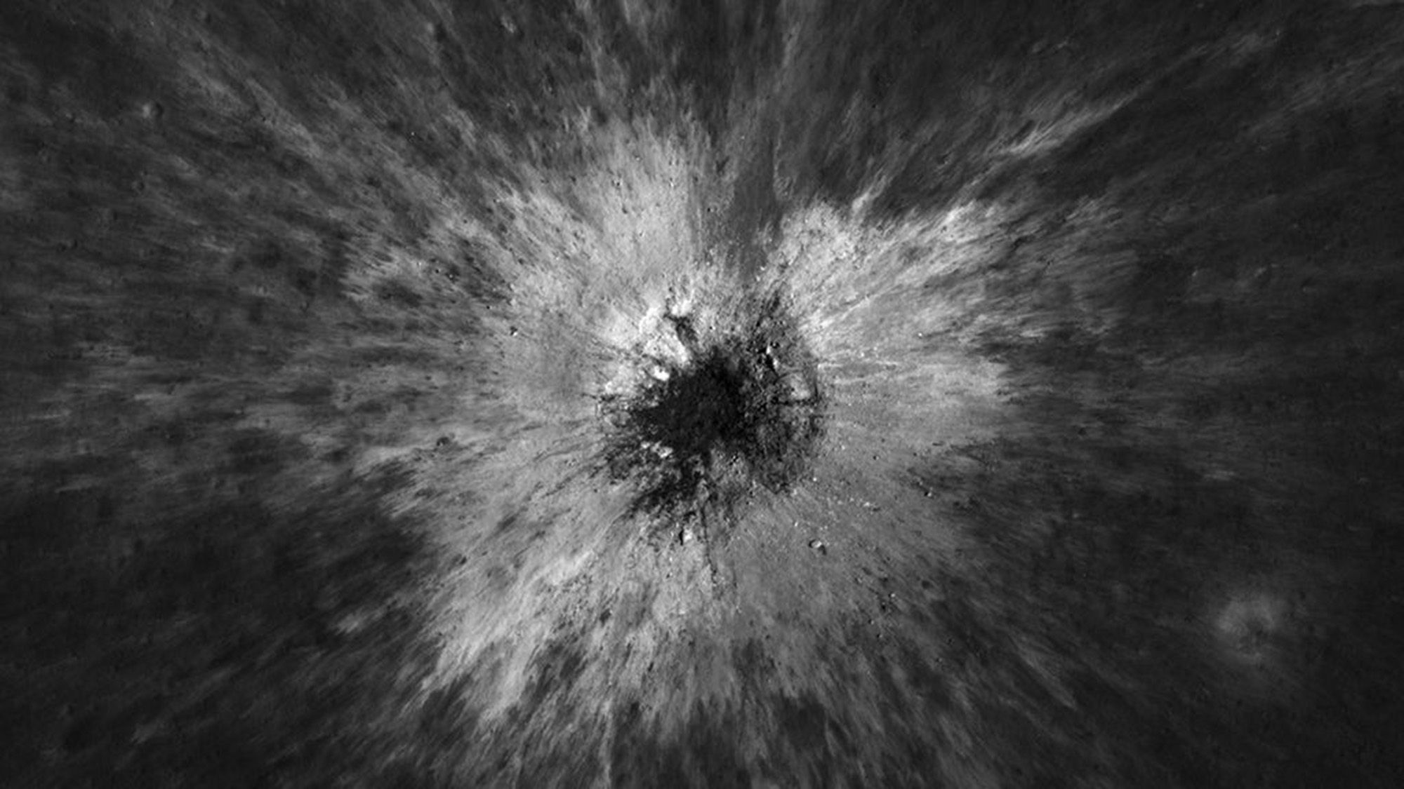 A black and white image of a crater on a gray surface