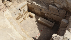 a view into a stone-lined tomb being excavated in Italy