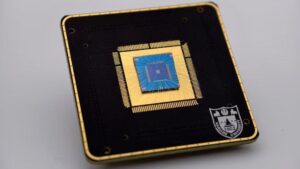 A close up of a brass and dark square with a circuit board on it.
