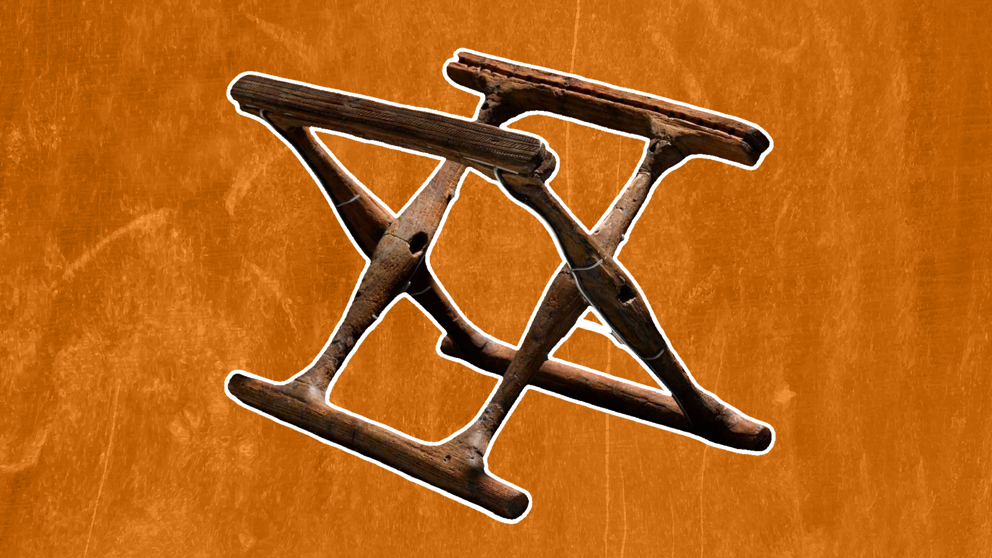 un cadre de chaise pliante en bois en forme de X sur fond orange