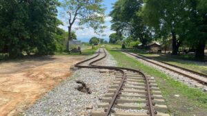 A view of metal railroad tracks curving due to the damage from an earthquake
