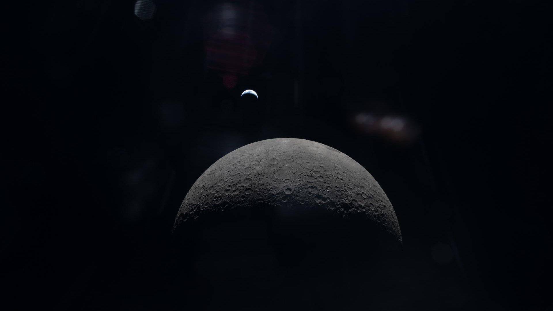 A view of the moon with the Earth in the background