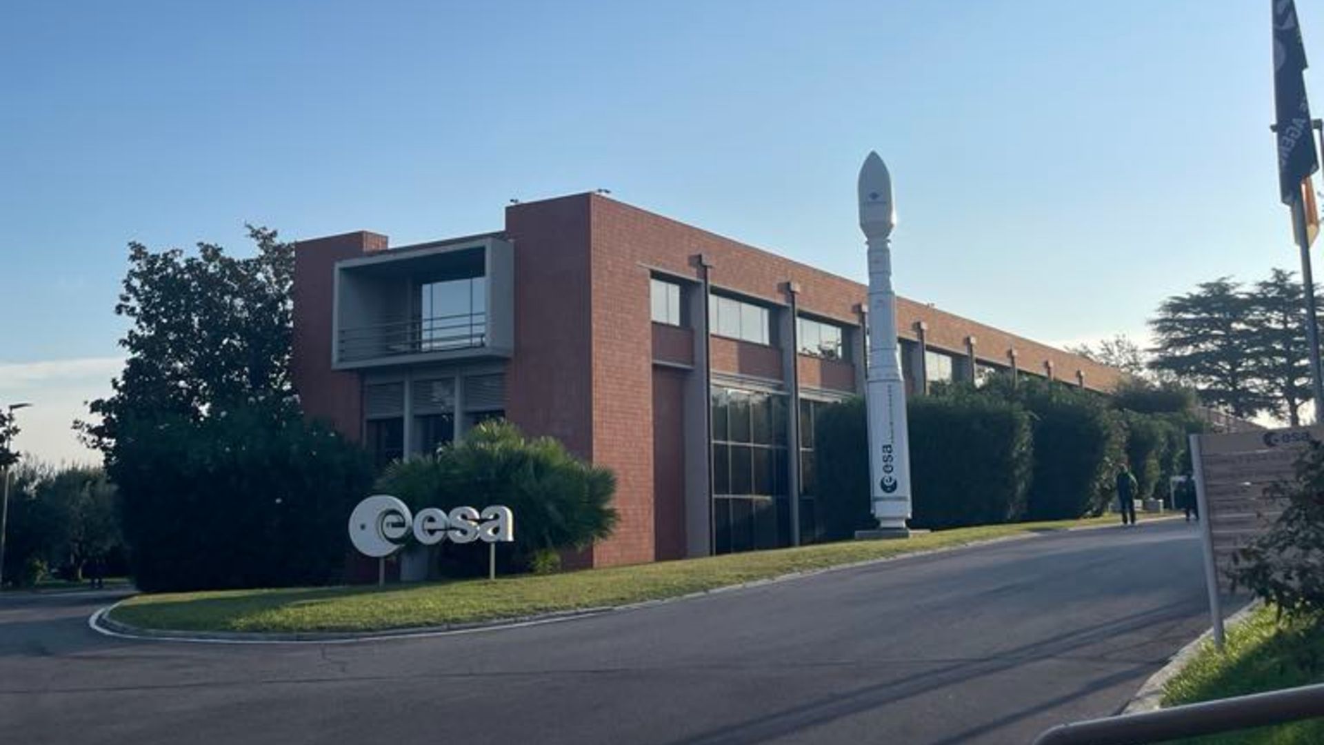 Une photo d'un panneau de l'ESA et d'une maquette de fusée à l'entrée du centre ESRIN à Frascati